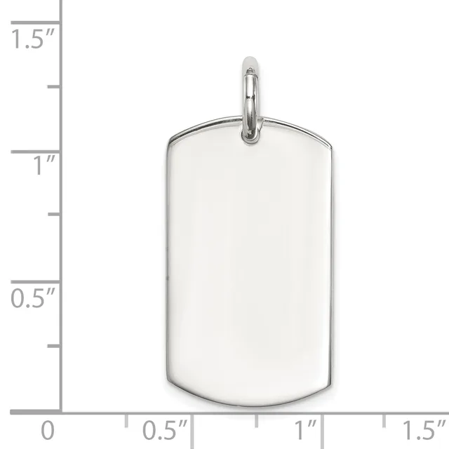 A polished stainless steel dog tag pendant with rounded rectangular shape and a small loop attachment at the top, shown next to a measurement scale.