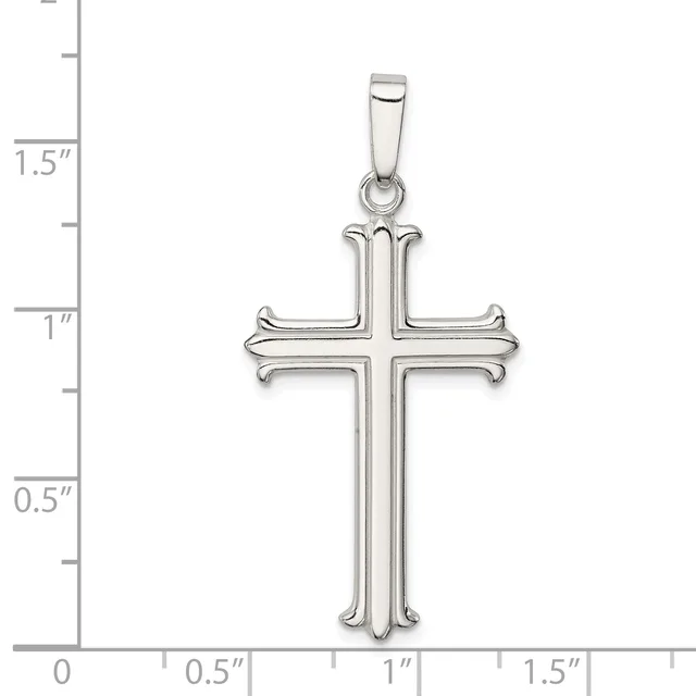 A silver cross pendant with curved ornamental ends on each arm, shown against a measurement scale indicating approximately 1.5 inches in height.