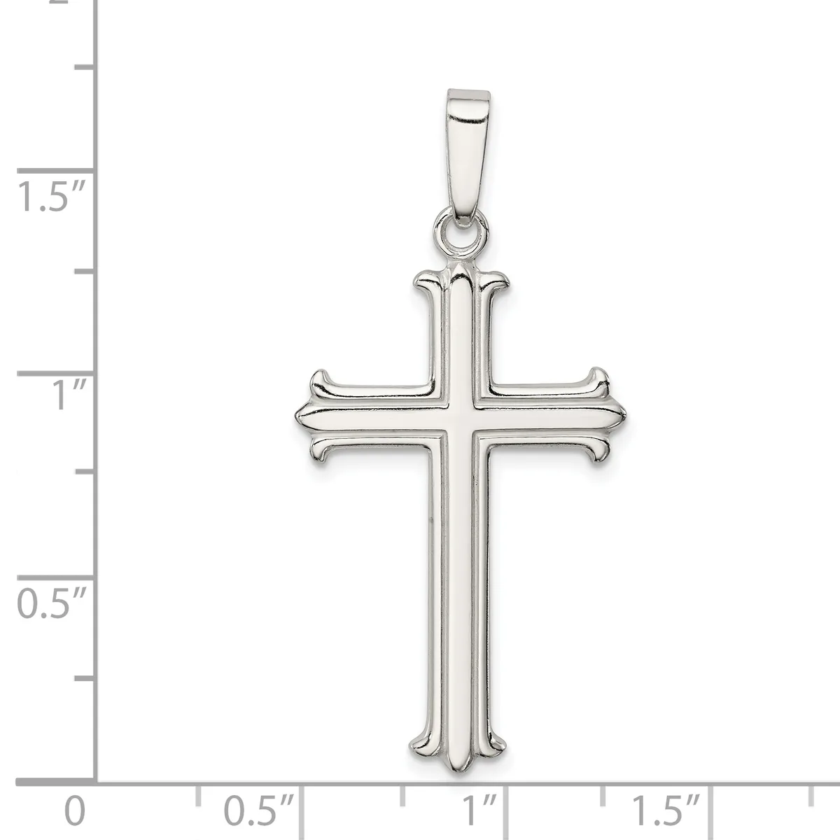 A silver cross pendant with curved ornamental ends on each arm, shown against a measurement scale indicating approximately 1.5 inches in height.
