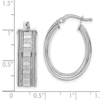 Two silver hoop earrings displayed against a measurement scale: a textured rectangular pendant earring and a smooth oval hoop earring with a post-and-ball closure.