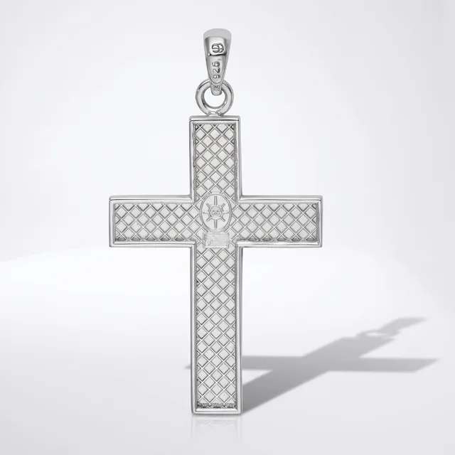 A silver cross pendant with a quilted diamond pattern surface and a small cross motif at its center, shown with its bail and shadow against a white background.