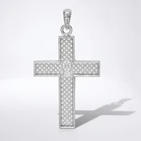 A silver cross pendant with a quilted diamond pattern surface and a small cross motif at its center, shown with its bail and shadow against a white background.