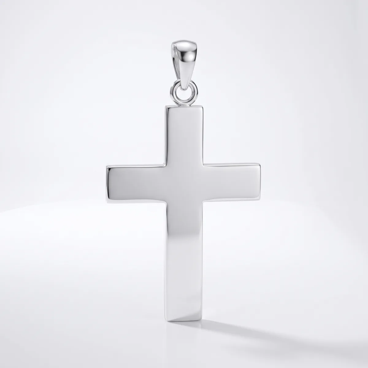 A polished silver cross pendant with a rectangular bail loop attached to the top, displayed against a white background.