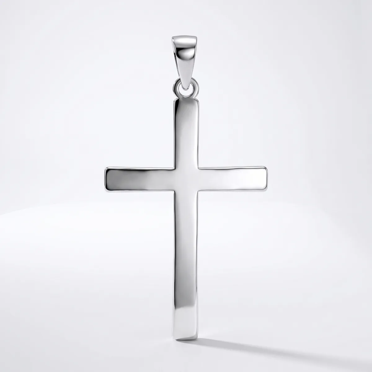A polished silver cross pendant with a rectangular outline design and small loop attachment at the top, displayed against a white background.