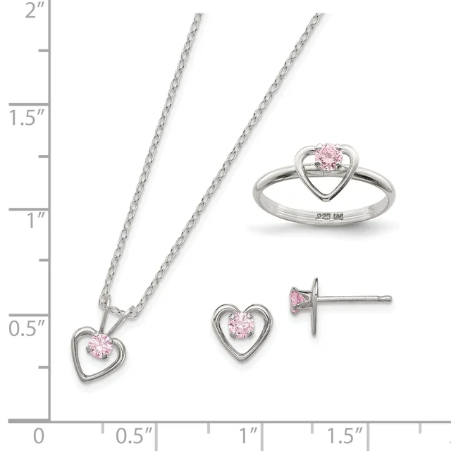 Three sterling silver jewelry pieces with pink cubic zirconia stones arranged on a measurement scale: a heart pendant necklace, matching heart stud earrings, and a heart ring.