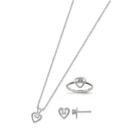 Three-piece sterling silver jewelry set with pink stones: a heart pendant on a chain, matching heart stud earrings, and a heart-shaped ring, displayed on white background.