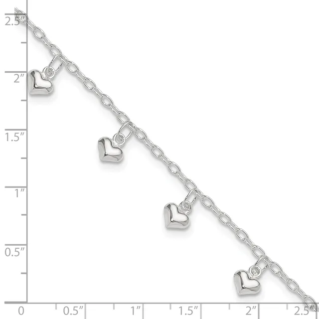 Silver chain bracelet with four small heart charms evenly spaced along its length, displayed against a ruler showing measurements in inches.