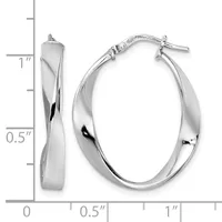 A pair of twisted oval hoop earrings in polished silver with a small hallmark, shown next to a ruler indicating approximately one inch in length.