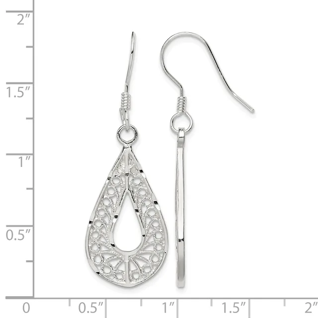A pair of silver teardrop filigree earrings with small dark stones, displayed next to a ruler showing they measure approximately one inch in length.