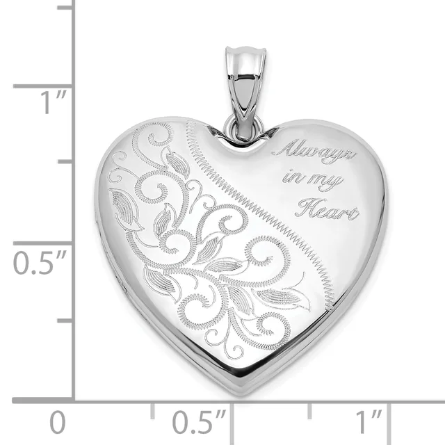 Sterling silver heart locket pendant with ornate scrollwork and leaf engraving on one side and "Always in my Heart" text on the other, shown with scale ruler.