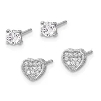 Two pairs of diamond stud earrings in white metal: one pair with single round brilliant diamonds, one pair with heart-shaped settings paved with smaller round diamonds.