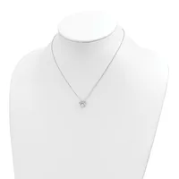 A delicate silver chain necklace with a small diamond solitaire pendant displayed on a white mannequin bust.