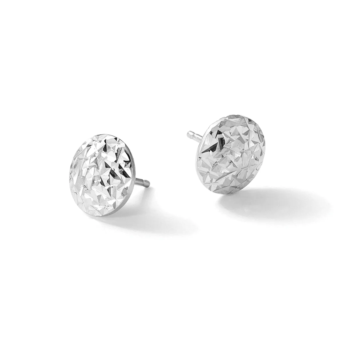 A pair of silver stud earrings with textured, hammered oval faces on posts against a white background.