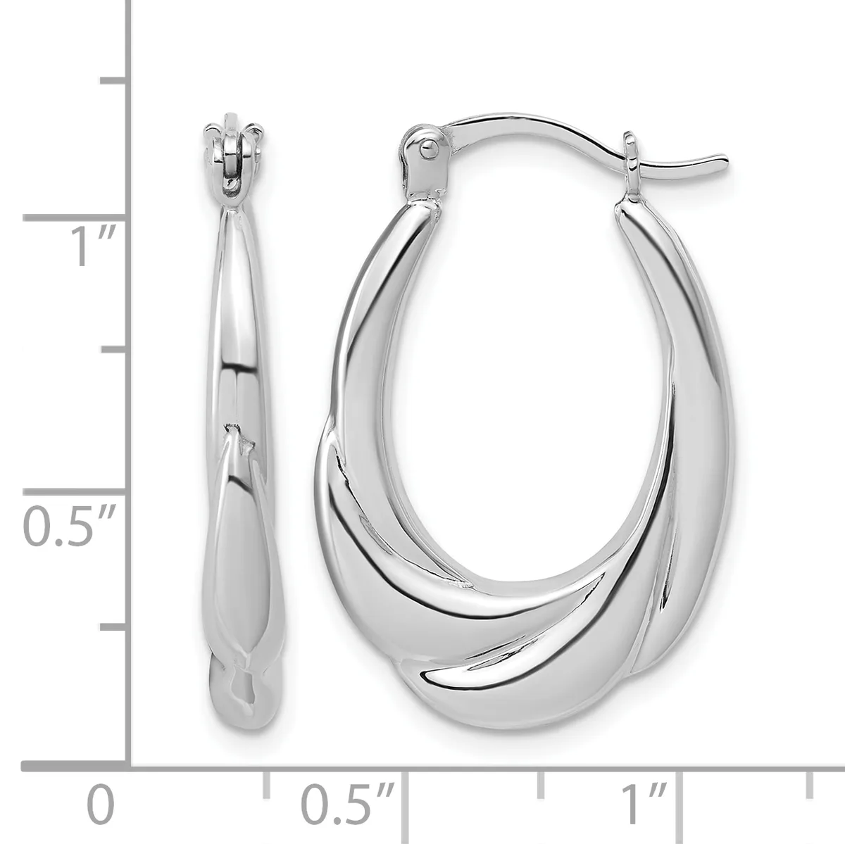 A pair of polished silver oval hoop earrings with a chunky tapered design, shown next to a measurement scale indicating approximately one inch in length.