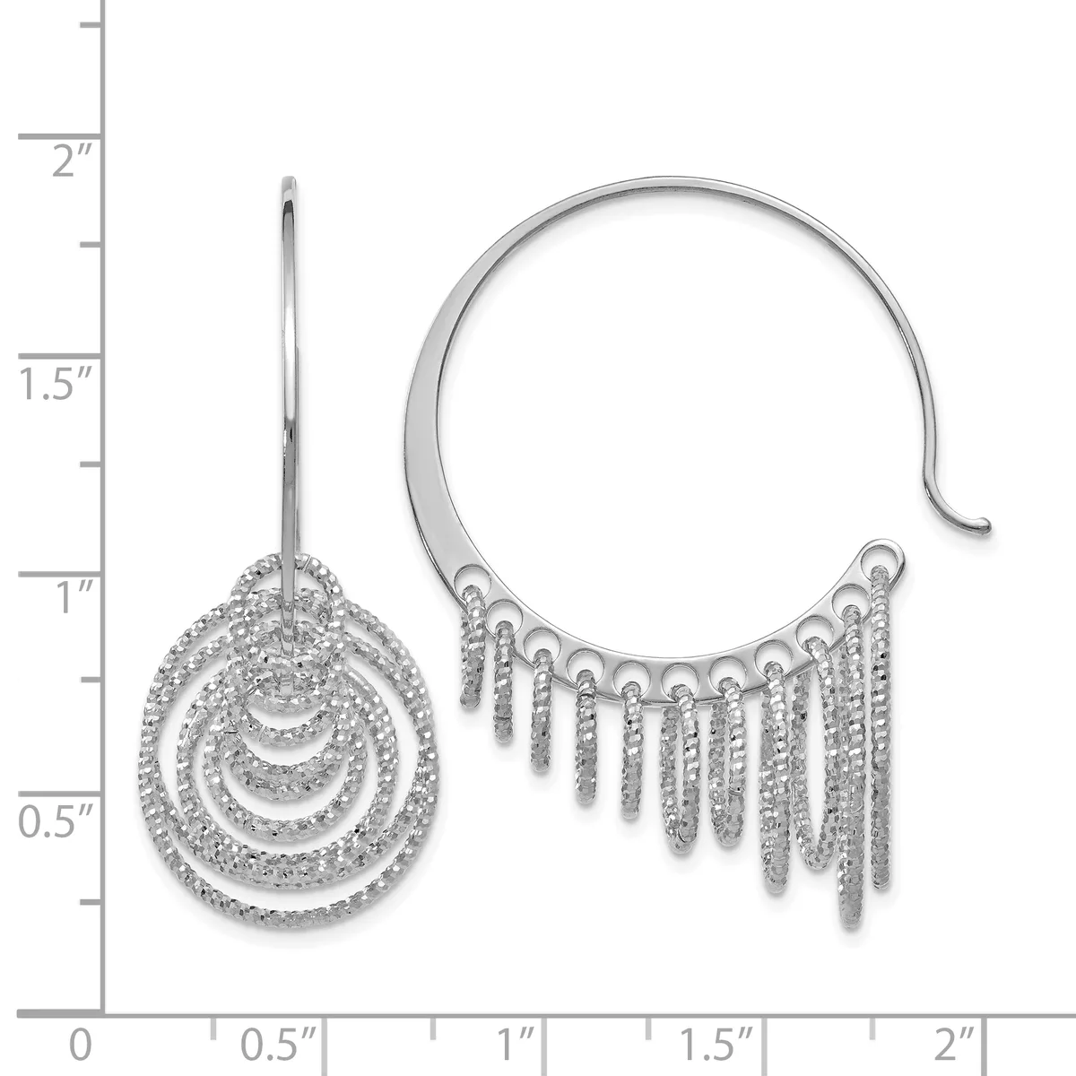 Two silver earrings with cubic zirconia stones displayed against a measurement ruler: a drop earring with concentric circular pendants on a post, and a curved cuff earring with fringe-like dangles along the bottom.