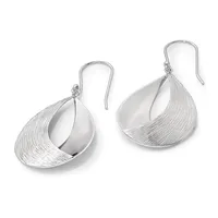A pair of silver teardrop-shaped earrings with textured surfaces and polished concave interiors, suspended from curved ear wires.