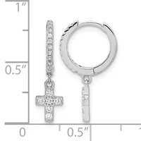 Silver huggie hoop earrings with dangling cross charms set with cubic zirconia stones, displayed on a measurement scale showing approximately one inch in length.
