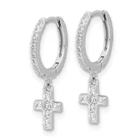Pair of silver hoop earrings with cubic zirconia pave setting and dangling cross charms embellished with cubic zirconia stones.