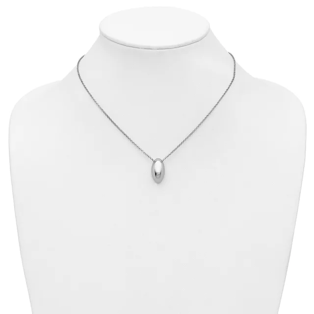 A silver teardrop-shaped pendant hangs from a delicate chain on a white mannequin bust.