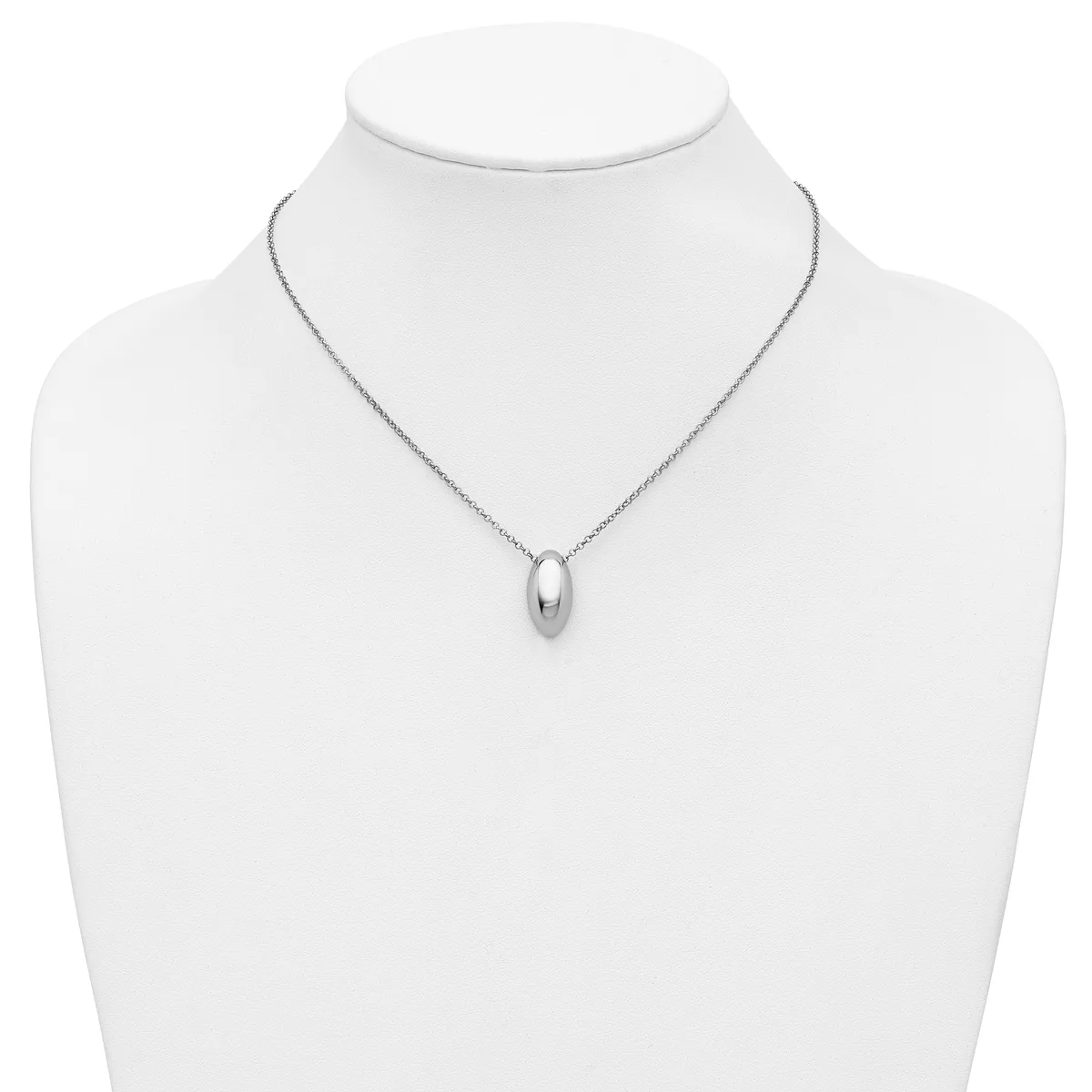 A silver teardrop-shaped pendant hangs from a delicate chain on a white mannequin bust.