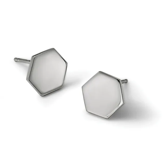 A pair of silver hexagonal stud earrings with polished domed faces and posts, displayed against a white background.