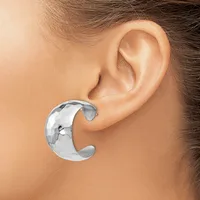 A polished silver crescent-shaped cuff earring worn on a person's ear, shown from the side view.
