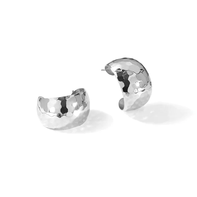 Two polished silver chunky curved hoop earrings with hammered texture, shown separately against a white background.