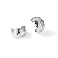 Two polished silver chunky curved hoop earrings with hammered texture, shown separately against a white background.