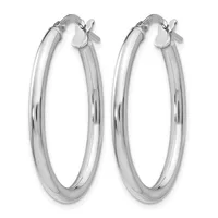 A pair of polished silver hoop earrings with a smooth, rounded profile and hinged closures, displayed against a white background.