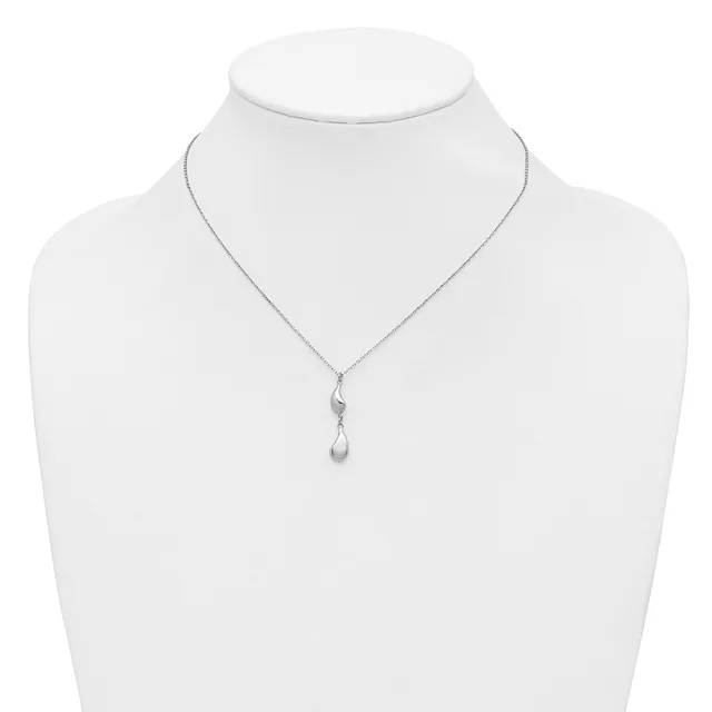 Silver necklace with a delicate chain and a teardrop-shaped pendant hanging from a small decorative bail, displayed on a white mannequin bust.