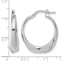 A pair of polished silver-toned chunky hoop earrings with hinged closures, shown next to a measurement scale indicating approximately one and one-half inches in length.