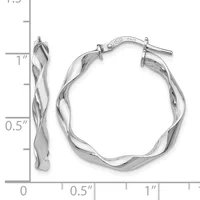 Pair of twisted silver hoop earrings with post and clutch closures, shown next to a ruler indicating approximately one inch in length.