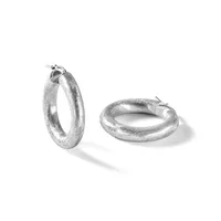 A pair of textured silver hoop earrings with a frosted finish, shown from two angles against a white background.