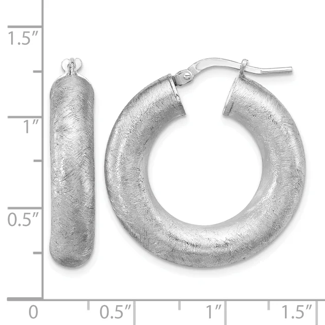 Pair of silver hoop earrings with a brushed texture finish and a measurement scale showing they are approximately one inch in diameter.