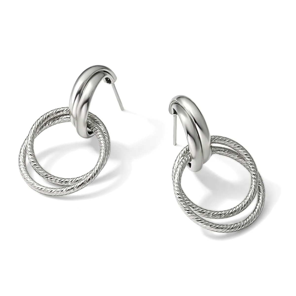 A pair of silver-toned double hoop earrings with textured outer rings and polished inner hoops, displayed against a white background.