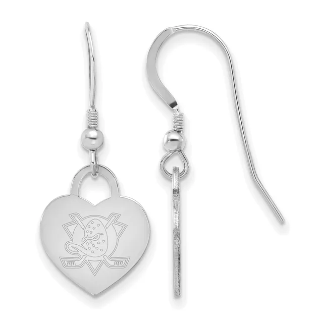 A pair of silver heart-shaped earrings with fish hook wires, featuring an engraved hockey puck and crossed sticks design on the front.