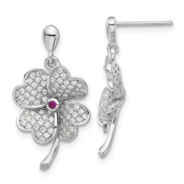 A pair of silver four-leaf clover drop earrings with diamond pave settings and a small ruby stone at the center, shown from front and side views.