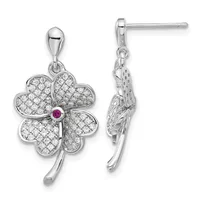 A pair of silver four-leaf clover drop earrings with diamond pave settings and a small ruby stone at the center, shown from front and side views.