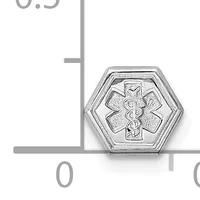 A hexagonal silver medical alert pendant with a Star of Life symbol in the center, shown against a measurement scale.