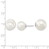 Three white pearl stud earrings displayed on a ruler showing sizes ranging from approximately one inch to two inches in diameter.