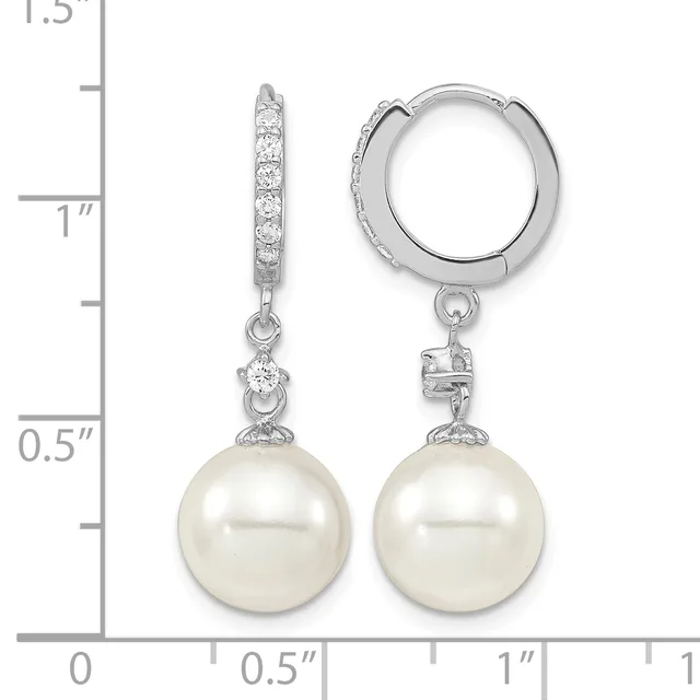 A pair of silver hoop earrings with diamond-accented posts and white pearl drops, displayed next to a measurement scale.