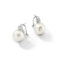 A pair of white pearl drop earrings with diamond accents and omega-style clip backs in white metal, displayed on a white surface.