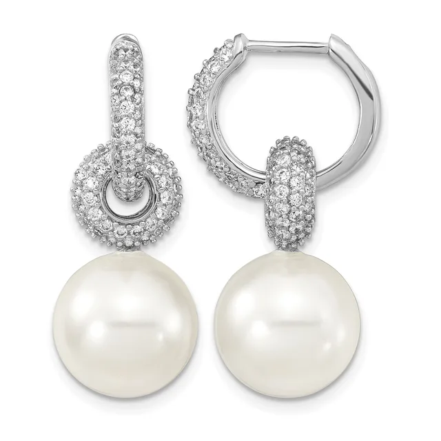Pair of silver huggie hoop earrings with cubic zirconia pave settings and white pearl drops.