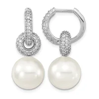Pair of silver huggie hoop earrings with cubic zirconia pave settings and white pearl drops.
