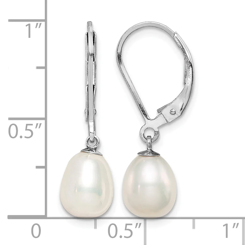 A pair of silver lever-back earrings with white pearl teardrop drops, shown next to a ruler indicating approximately one inch in length.