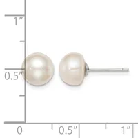 A pair of white pearl stud earrings displayed next to a ruler showing they measure approximately 0.5 inches in diameter.