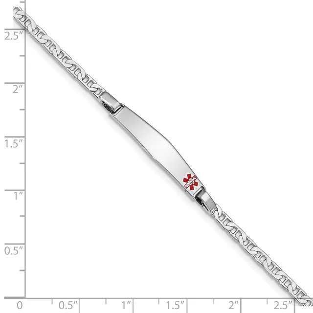 A medical alert bracelet with a white rectangular panel displaying a red caduceus symbol, attached to a decorative chain, shown against a measurement scale.