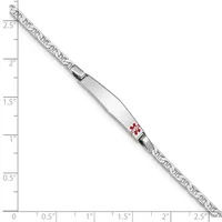 A medical alert bracelet with a white rectangular panel displaying a red caduceus symbol, attached to a decorative chain, shown against a measurement scale.