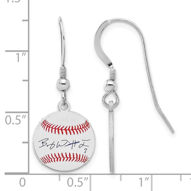 A pair of silver-toned baseball earrings with fish hook wires, featuring white enamel baseball charms with red stitching and a handwritten signature, shown against a measurement scale.