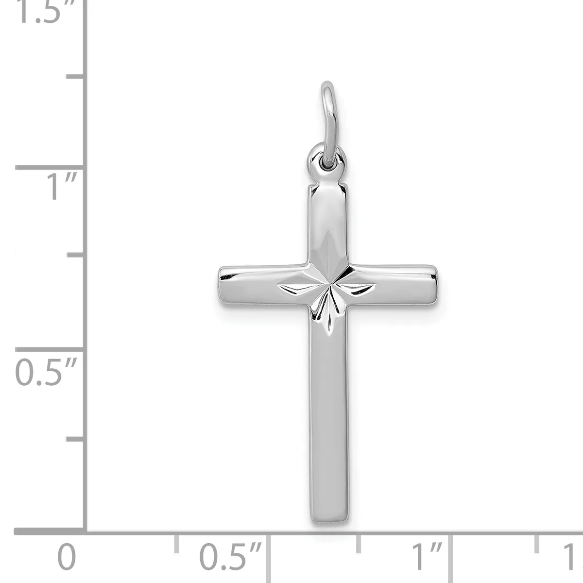 A polished silver cross pendant with a decorative star motif at the center, shown next to a ruler indicating approximately one inch in height.